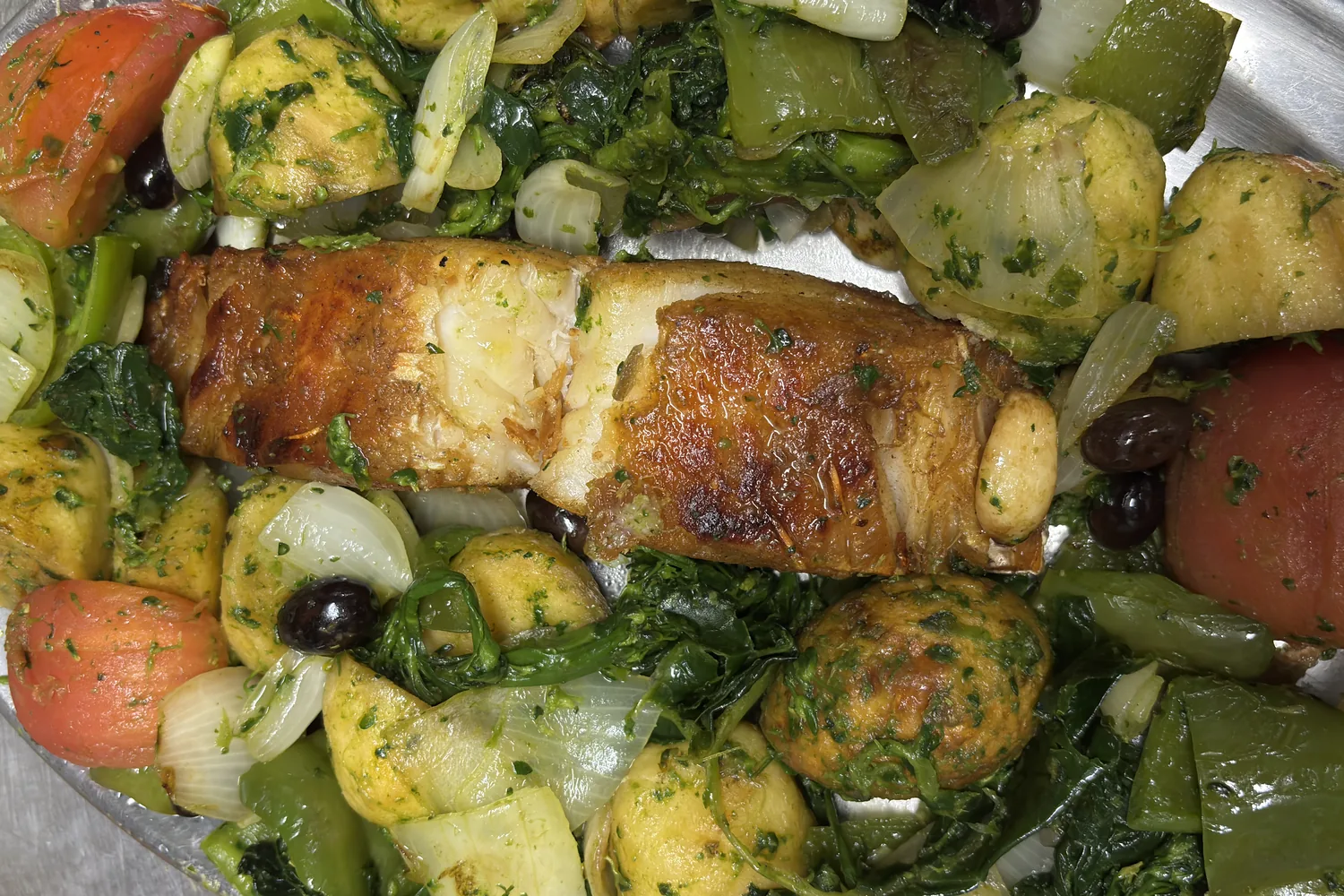 Hera's grilled cod fillet served with potatoes and sautéed vegetables