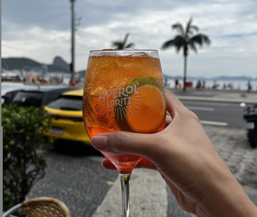 A drink served at Hera with Copacabana beach behind it