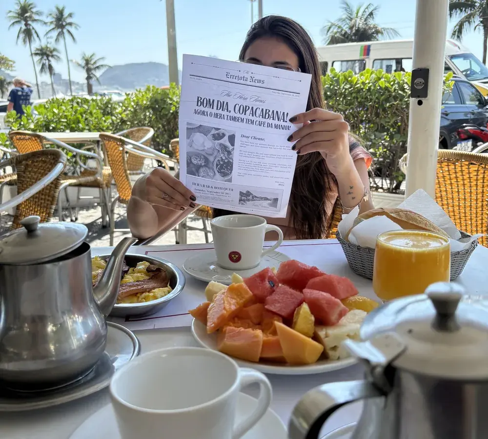Breakfast served on Hera's sidewalk with a coffee pot, seasonal fruit and juice