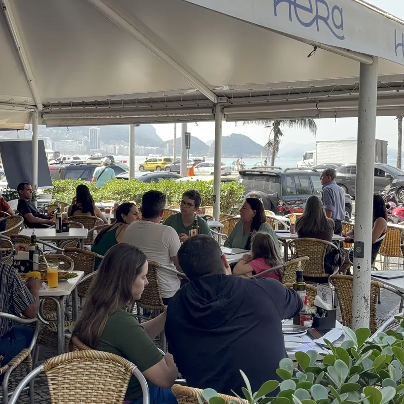 Hera's dining room under the awning with a view of the beachfront