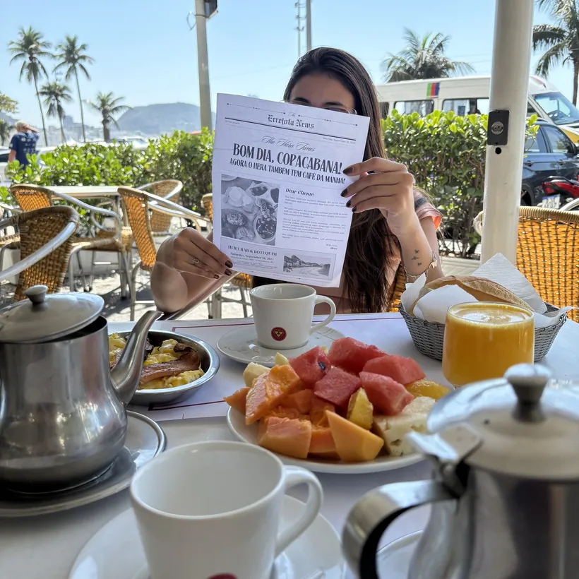 Breakfast at Hera served on the sidewalk with a coffee pot, fruit and juice