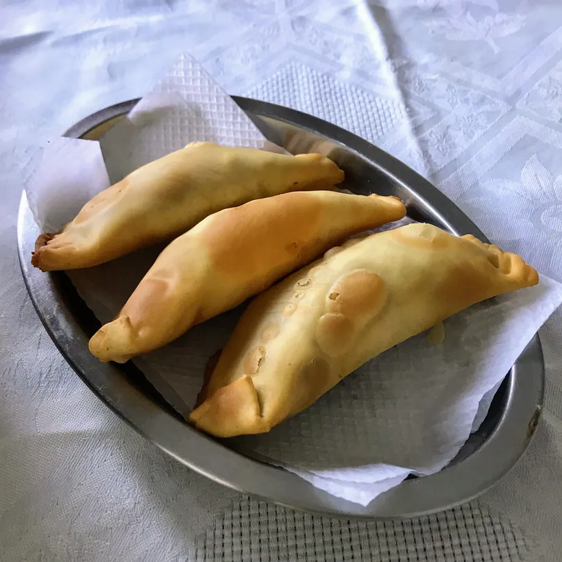 Fried pastéis served on a platter at Hera