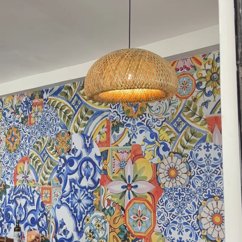 Wicker lamp and Portuguese tile wall in Hera's dining room