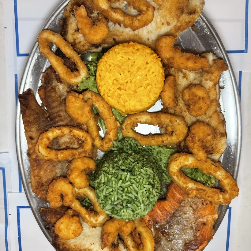 Mixed seafood platter: squid, breaded shrimp and grilled salmon