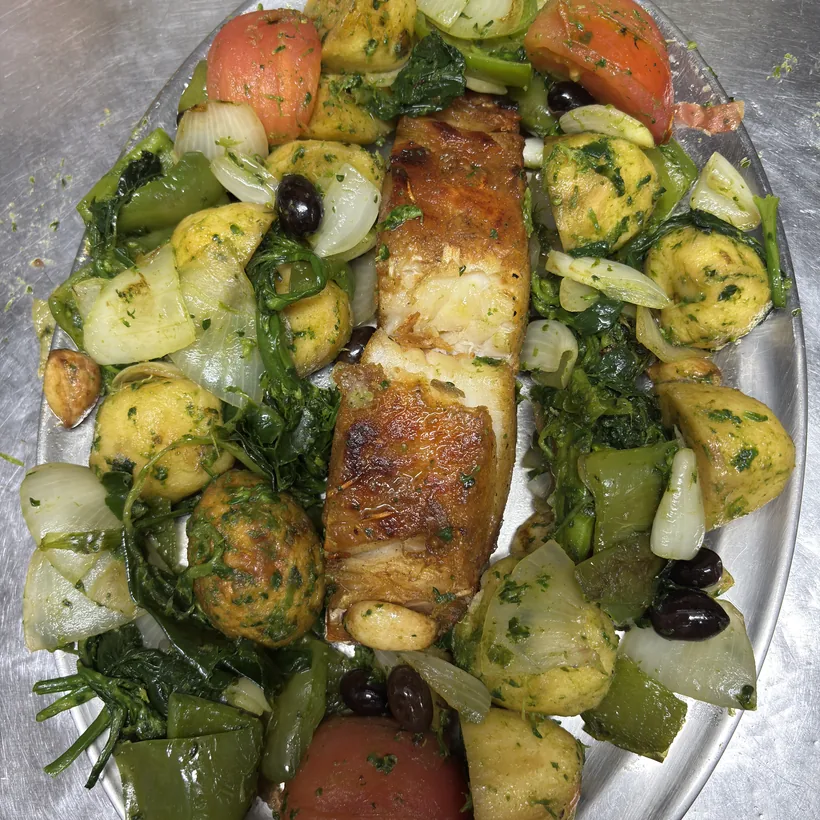Roasted cod with vegetables in olive oil and herbs