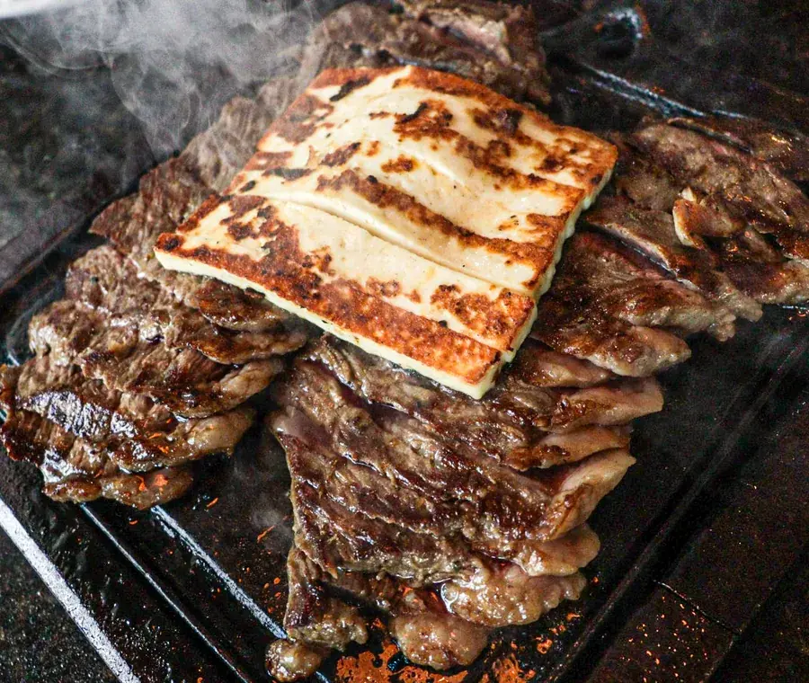 Picanha à Daniel with grilled coalho cheese on top, straight off the grill